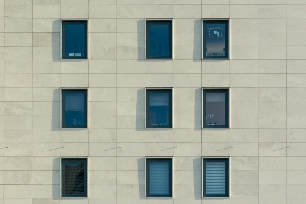 Geometric pattern of windows on a modern office building facade.