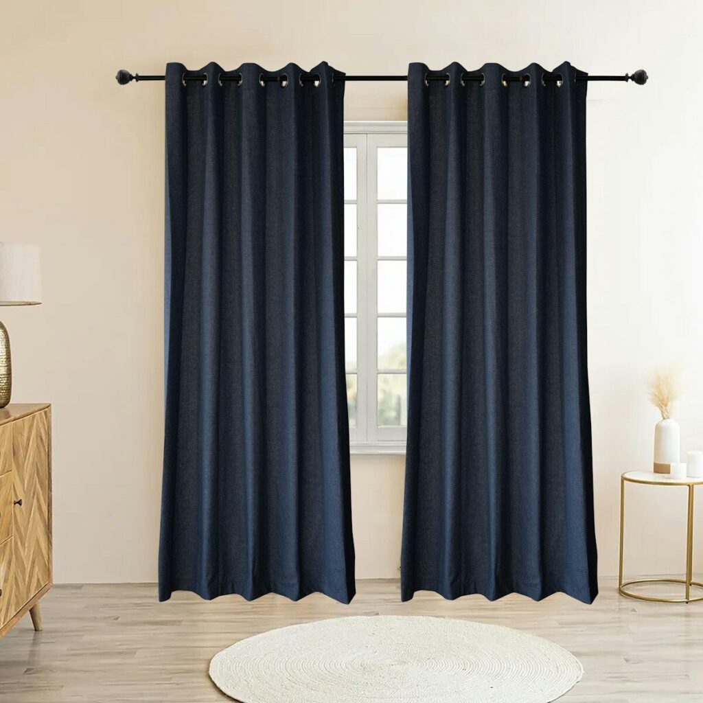 Dark blue curtains hang from a rod above a window.